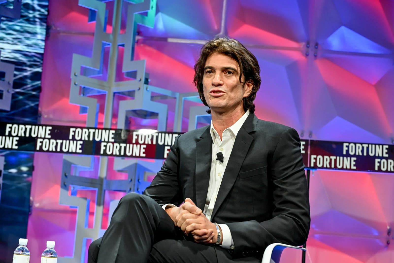 Adam Neumann speaking on stage at a Fortune conference