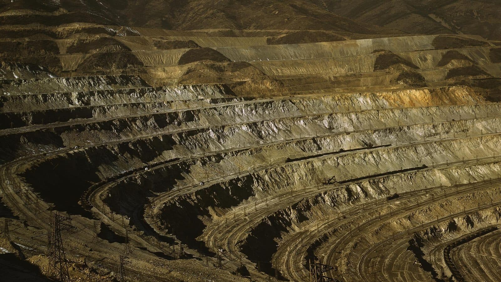 Aerial view of the terraced open pit walls of a large copper mine